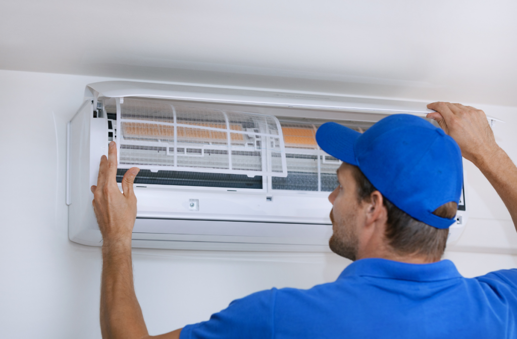 What is ductless air conditioning? A technician installs a mini split unit.